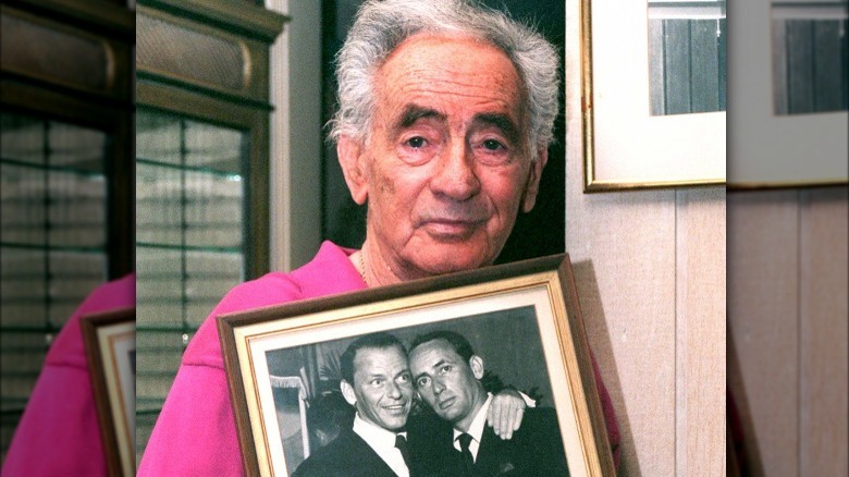 Bishop holding a framed photo