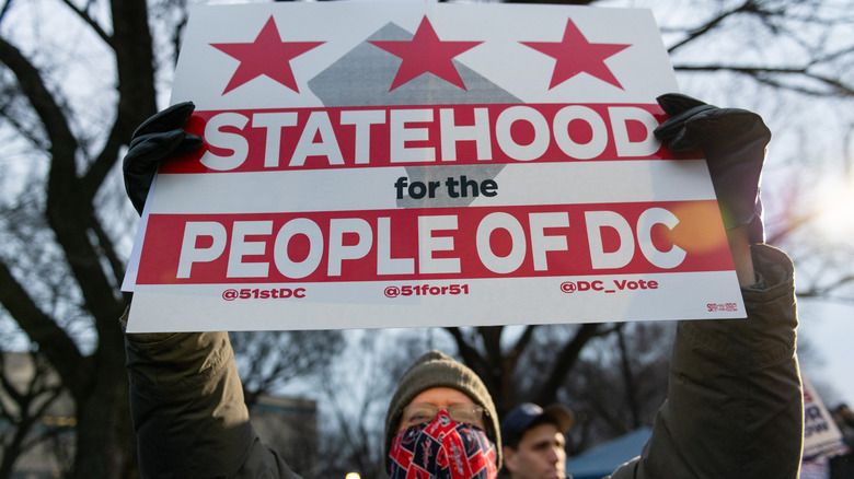 Campaigner holds a sign