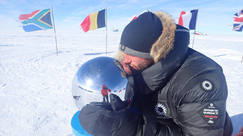 a researcher kissing the south pole