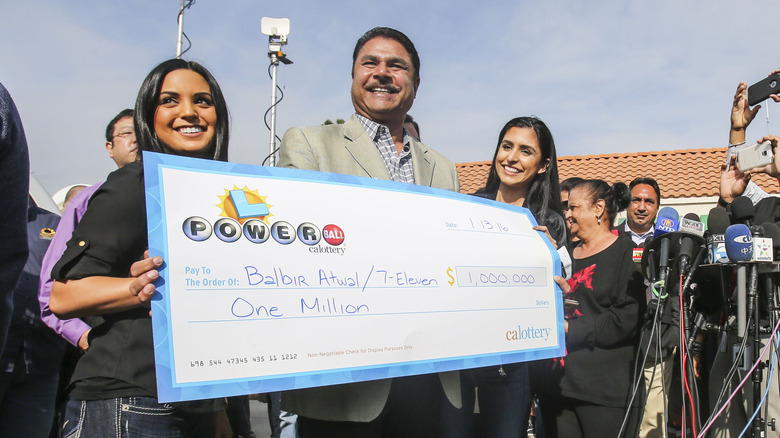 lottery winner publicly receives giant novelty check