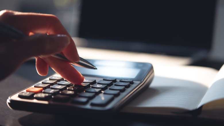 hand operating a calculator