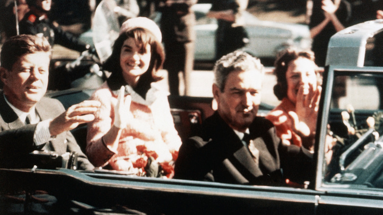 side view of presidential motorcade with kennedys and connallys in 1963