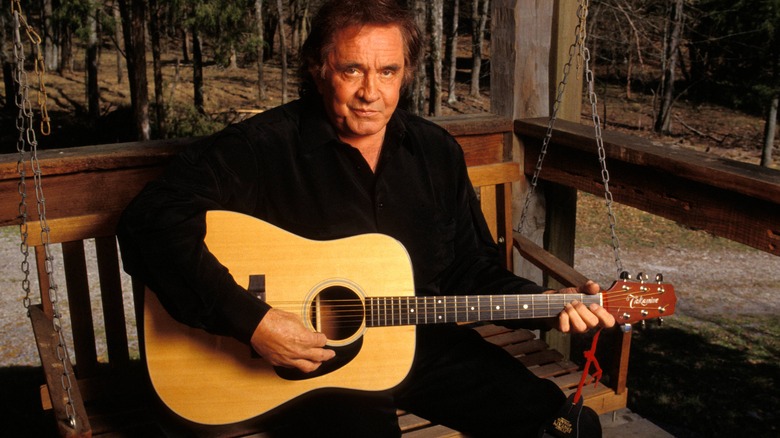 Johnny Cash holding acoustic guitar