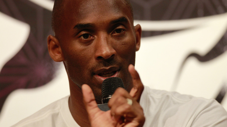 Kobe Bryant speaking into microphpne