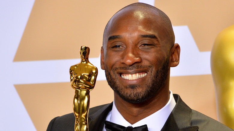 Kobe Bryant smiling holding award