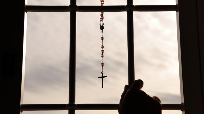 Rosary hanging from window