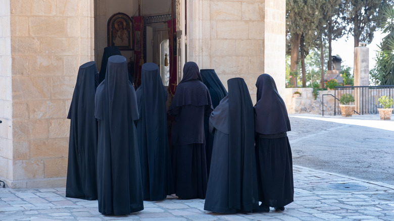 Russian orthodox nuns entering church