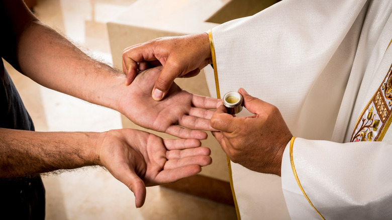 a catholic priest performs a rite