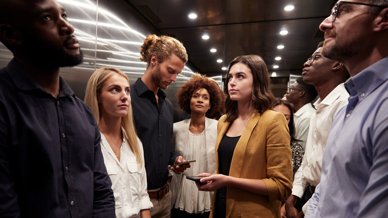 Several people in a crowded elevator