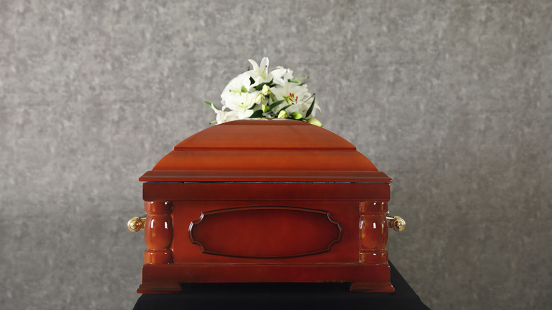 casket with flowers on lid