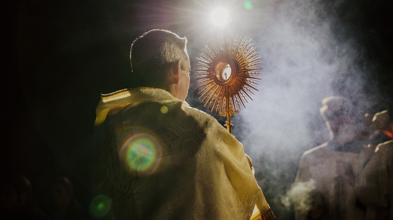 Catholic priest praying