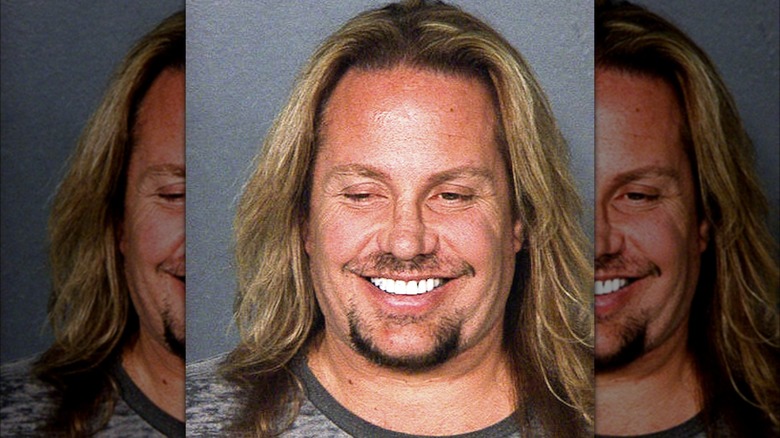 Motley Crue's Vince Neil smiling in mugshot 