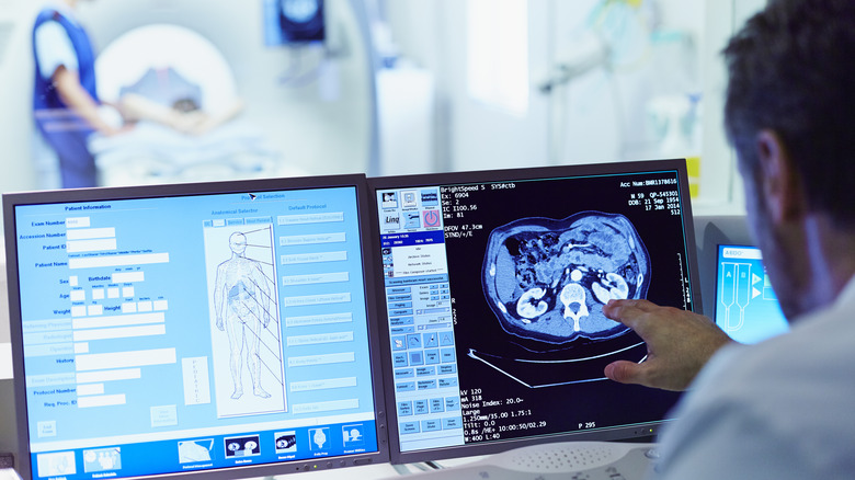 Technician analyzing CT scan readout