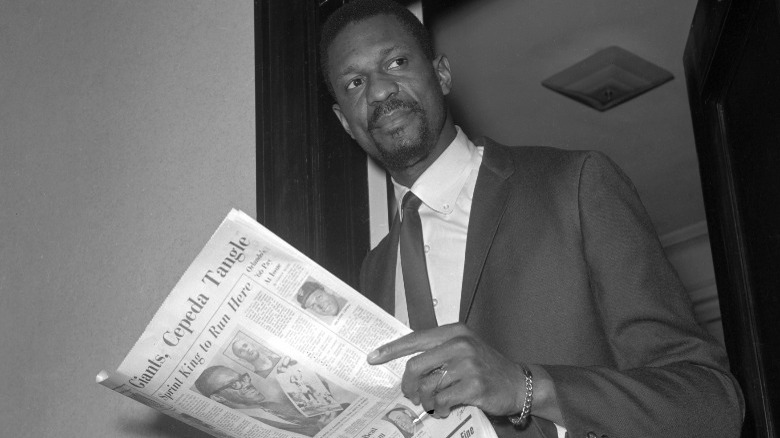 younger Bill Russell holding newspaper