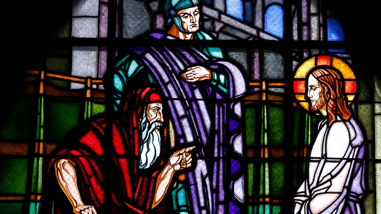 Stained glass window showing Sanhedrin official questioning Jesus