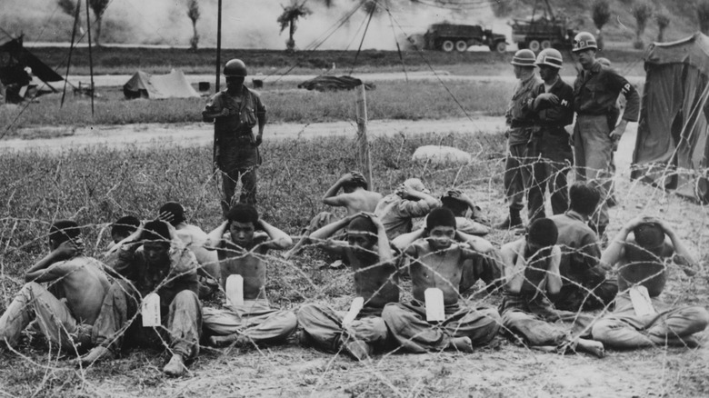 North Korean prisoners of war being watched by US soldiers