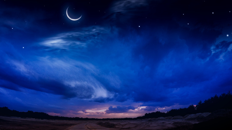 Crescent moon rising at night