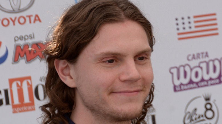 Evan Peters smiling starting to side