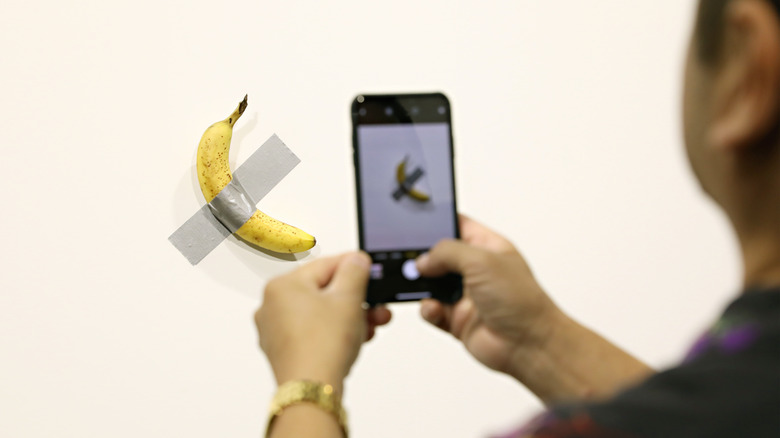 banana taped wall camera phone