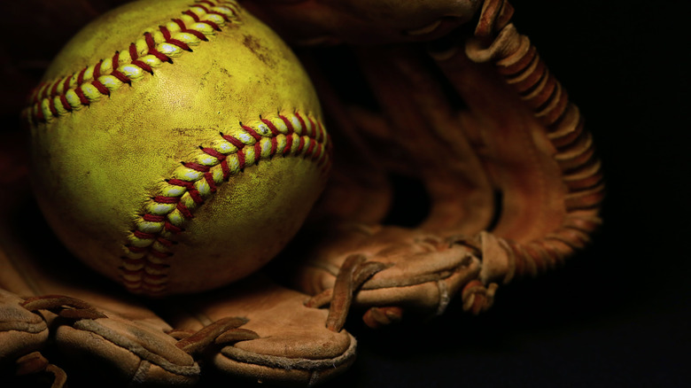 Softball resting in glove