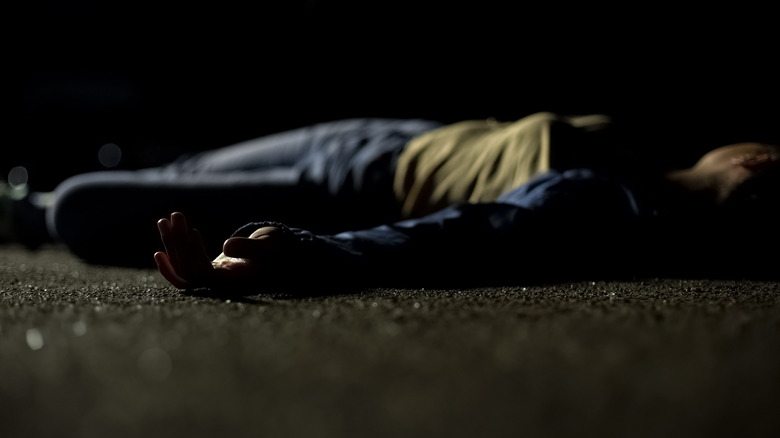 Female victim lying on road