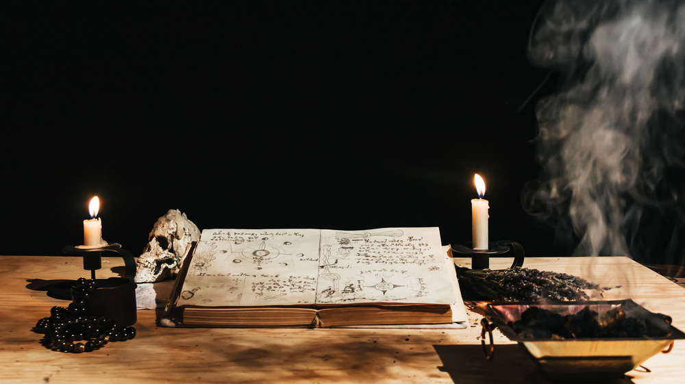 candles and book on a wooden table