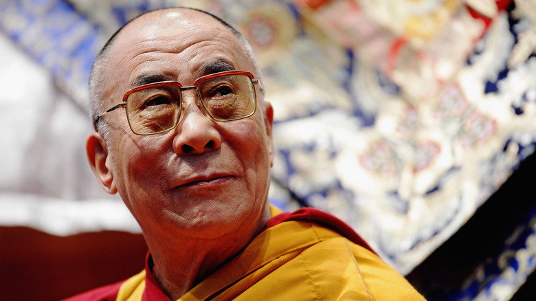 The Dali Lama poses for a photo