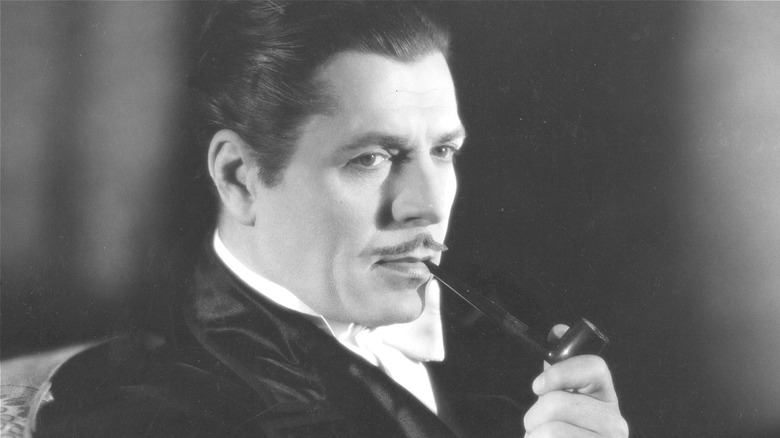 Warner Baxter in smoking jacket