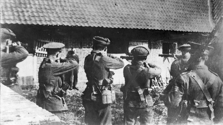 Soldier facing a firing squad with their rifles raised