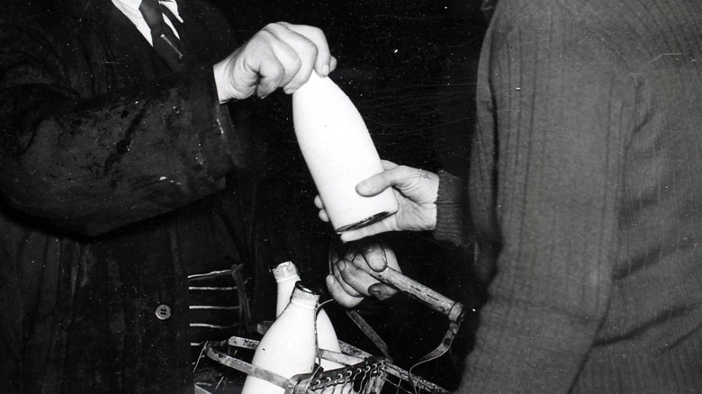 milkman handing milk to customer