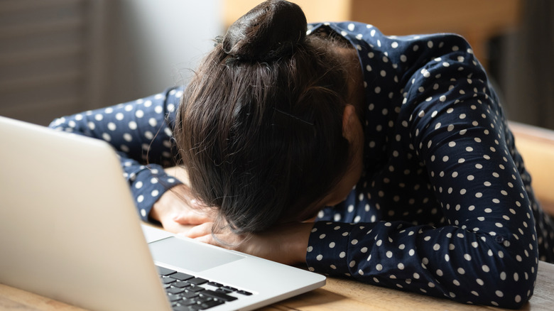 A woman asleep at her desk