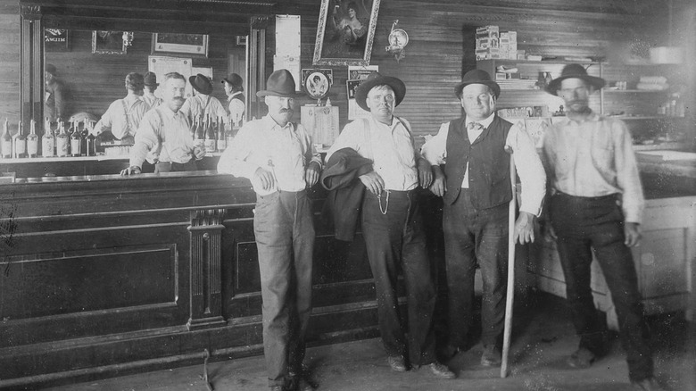 group of people standing at a western saloon