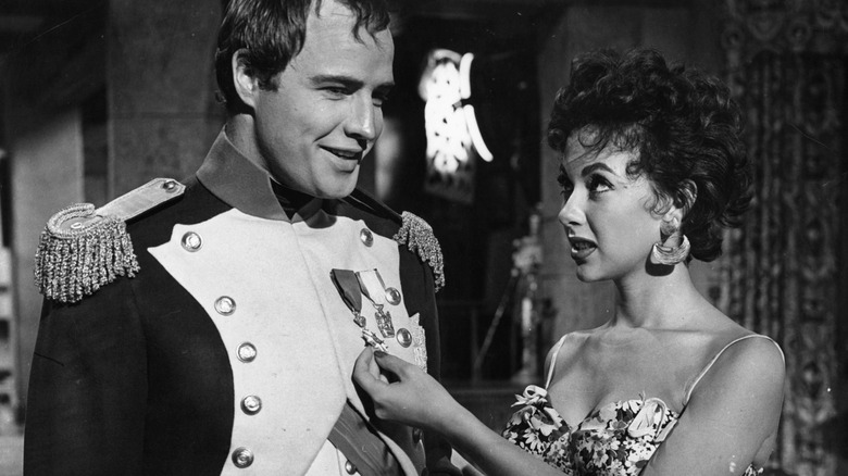 Marlon Brando and Rita Moreno on film set