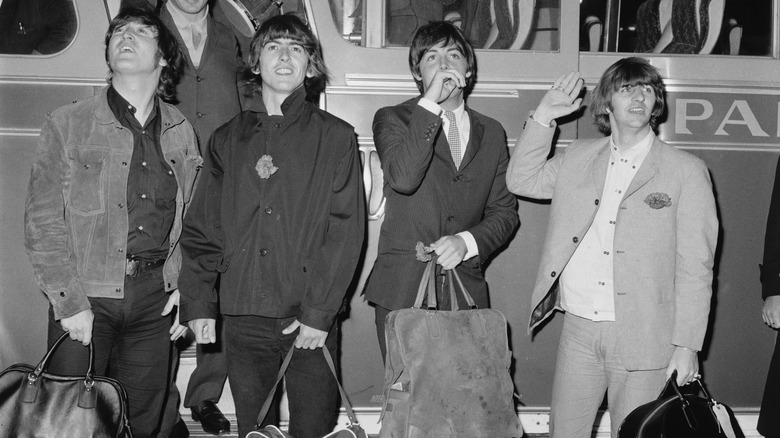 The Beatles getting off a bus