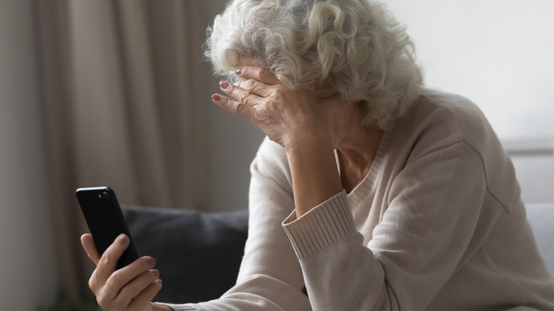 Older woman stressed phone