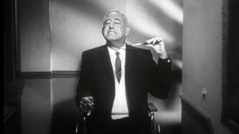 William Castle holds knife to his throat in intro for "Homicidal."