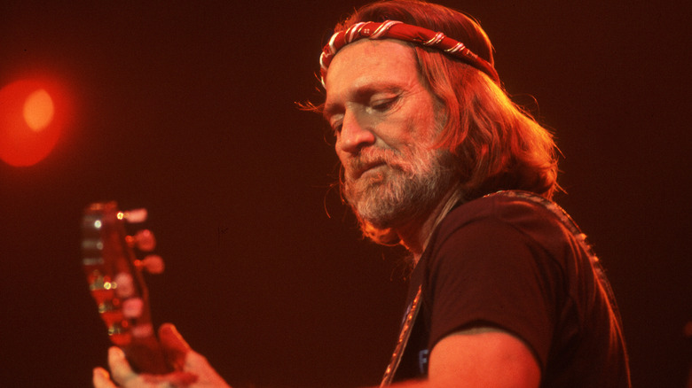 Willie Nelson playing guitar