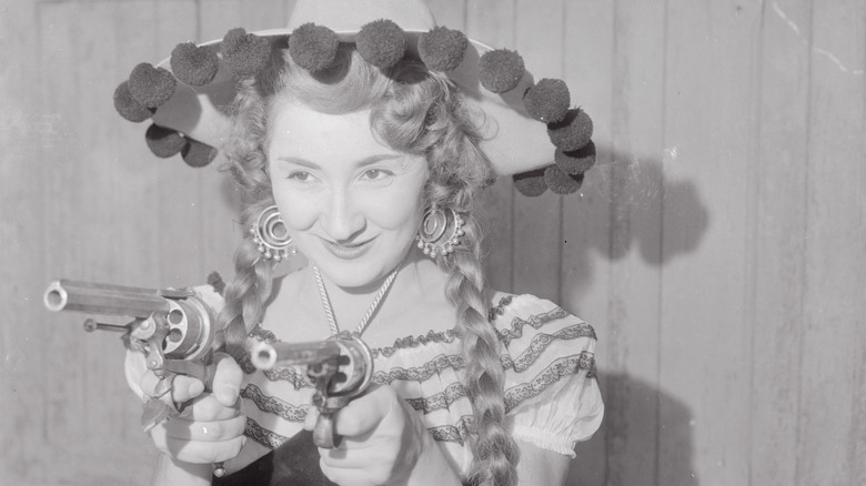 Anna Caglio dressed as cowgirl with pistols and hat