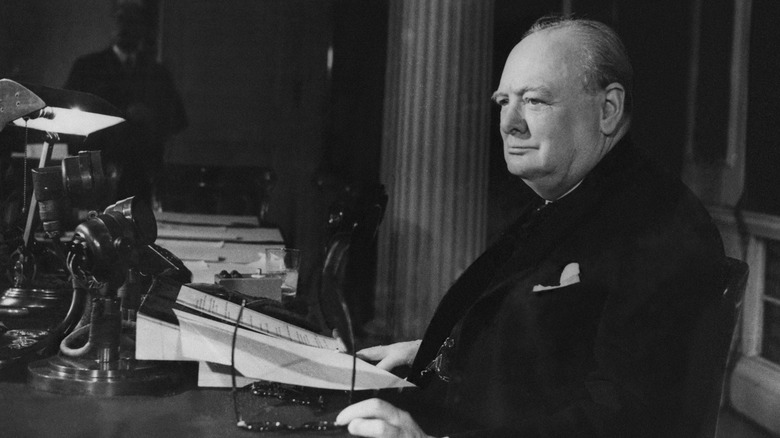 Winston Churchill reading at desk