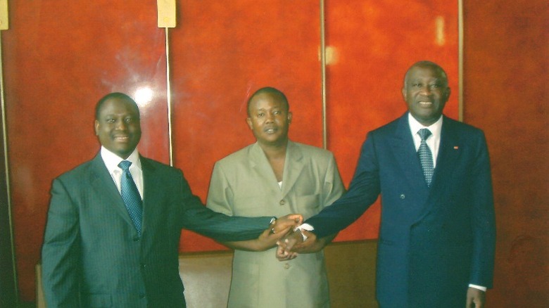 Laurent Gbagbo with two other men