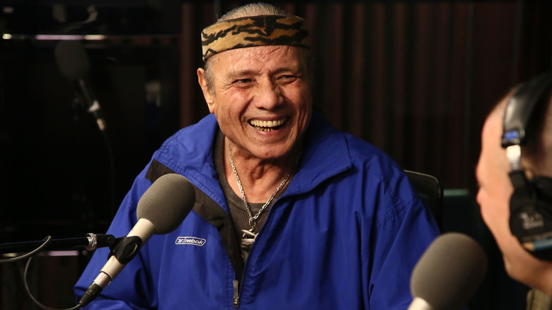 Jimmy Snuka sat laughing blue jacket radio studio