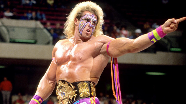 The Ultimate Warrior pointing face paint in ring