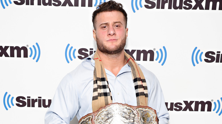 MJF posing with belt against SiriusXM background