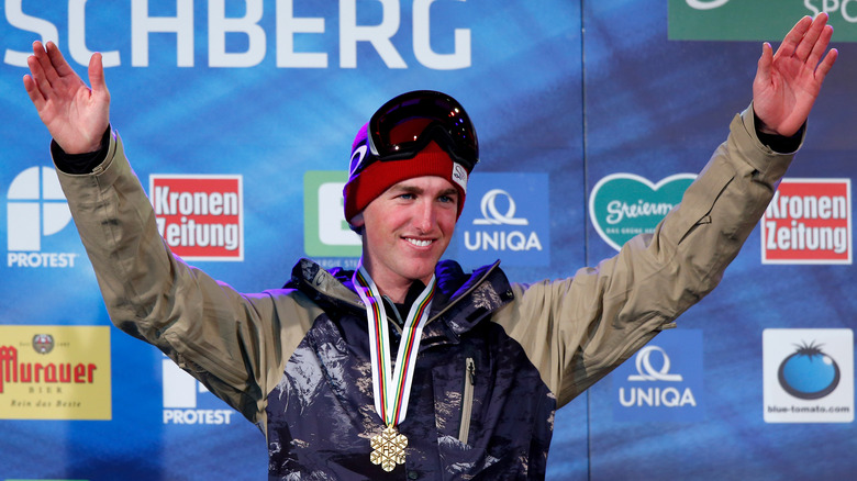 Kyle Smaine arms raised smiling championship medal