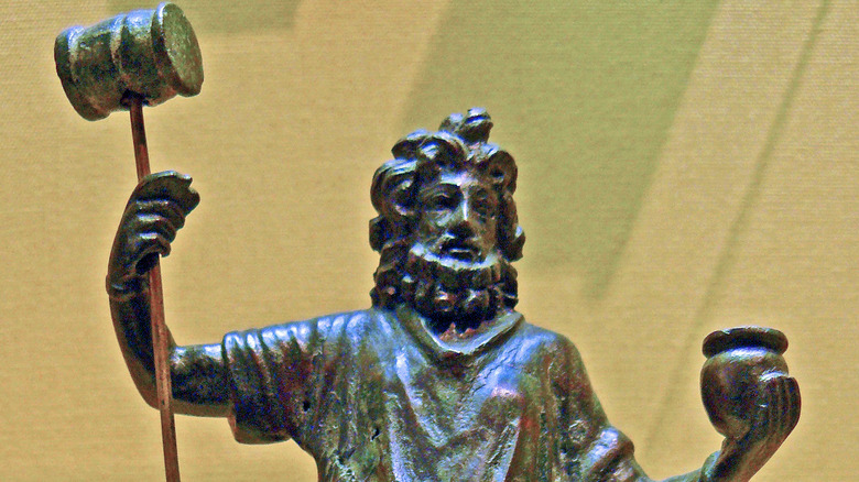 succellus statue holding pot and hammer