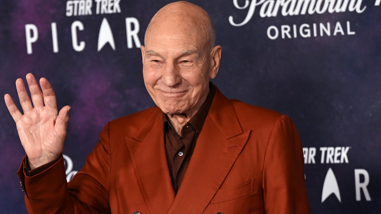 Patrick Stewart on the red carpet waving