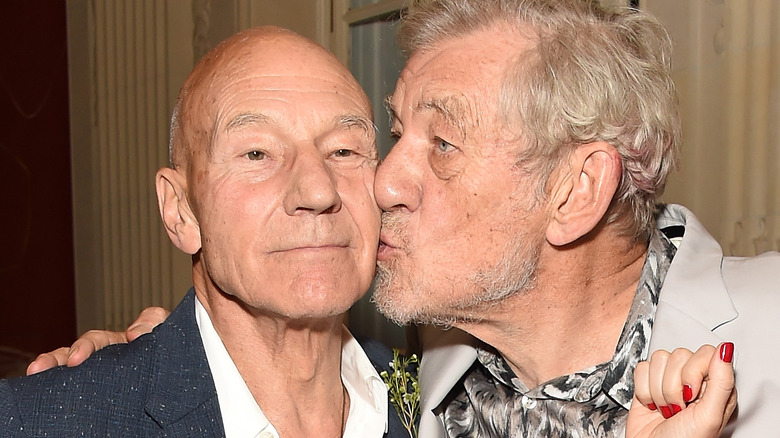 Ian McKellen kissing Patrick Stewart on the cheek