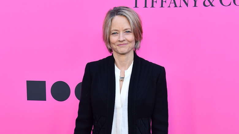 Jodie Foster standing in front of pink background