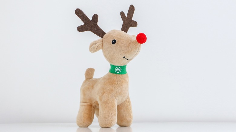 A stuffed reindeer with a red nose