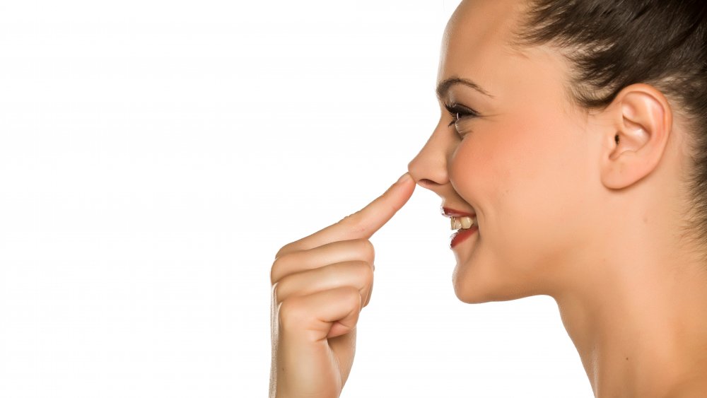 woman touching nose